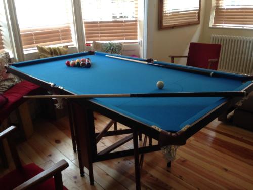 a pool table with balls on it in a living room at Two Top Central Unique Artisan Beach Studios - also separate spa cabin in Brighton & Hove