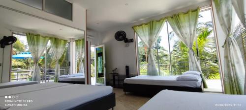 a bedroom with two beds and a window at CASA VACACIONAL CAMPOSOL in Melgar