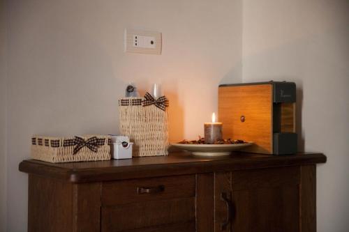 a table with a candle and a microwave on it at La corte di Ercole in Alberobello