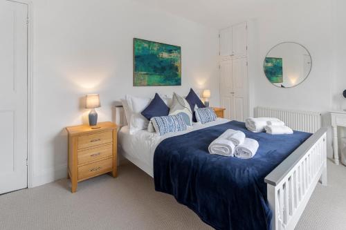 a bedroom with a large bed with towels on it at 9 Riverside in Sidmouth