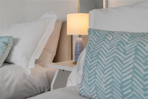 a bedroom with a bed and a lamp on a table at 9 Riverside in Sidmouth