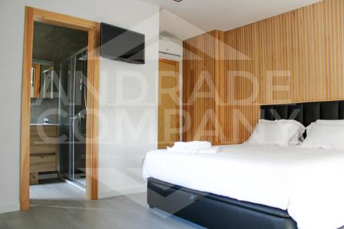 a bedroom with a bed and a glass shower at Casa da Padaria Antiga 2 in Pinhão