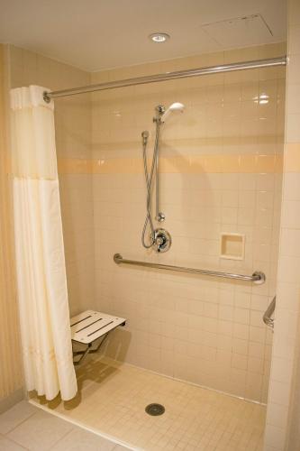 a bathroom with a shower with a shower curtain at The Inn at Virginia Tech - On Campus in Blacksburg