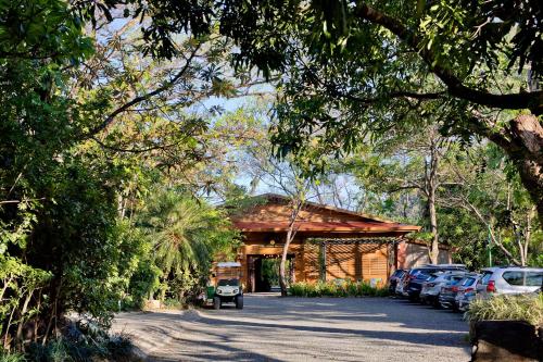 a building with cars parked in a parking lot at Hacienda Guachipelin Volcano Ranch Hotel & Hot Springs in Liberia