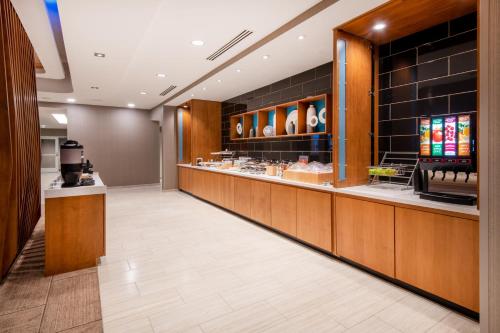 a restaurant lobby with a counter with food at SpringHill Suites by Marriott Franklin Cool Springs in Franklin