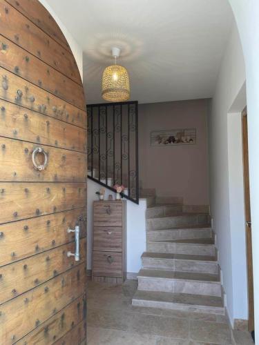 a hallway with stairs and a wooden wall at Casa Ditta in Mela