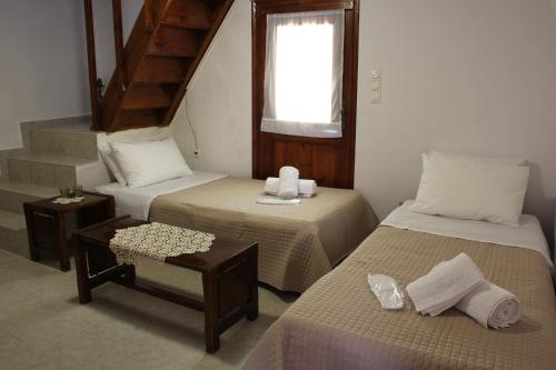 A bed or beds in a room at Evanthea Residence