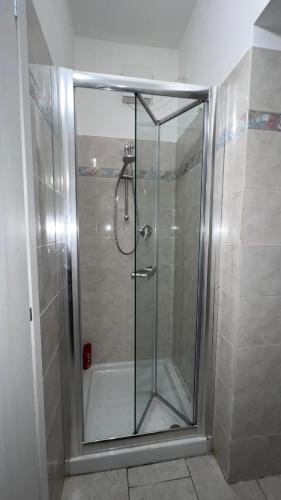 a shower with a glass door in a bathroom at Casa di Mery in Massa Lombarda