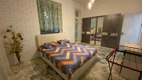 a bedroom with a bed and a large mirror at Duplex80 in Tashkent