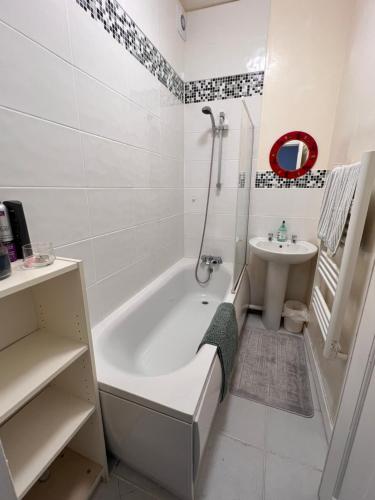 a white bathroom with a tub and a sink at Lovely - 1 Bedroom Flat in Hastings Town Centre in Hastings