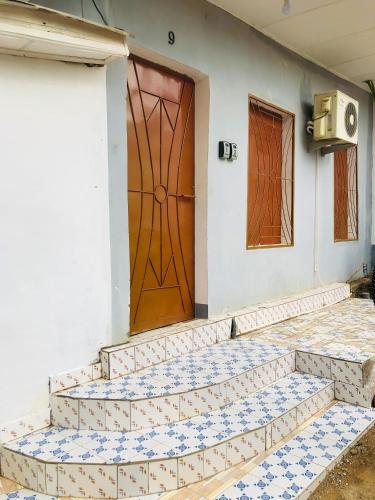 a front door of a house with blue and white tiles at Chez Catherine et Gabriel in Bangui