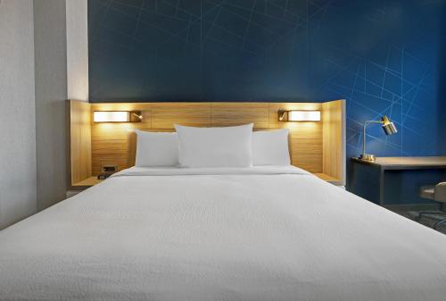 a bedroom with a large white bed with a blue wall at SpringHill Suites by Marriott Franklin Cool Springs in Franklin