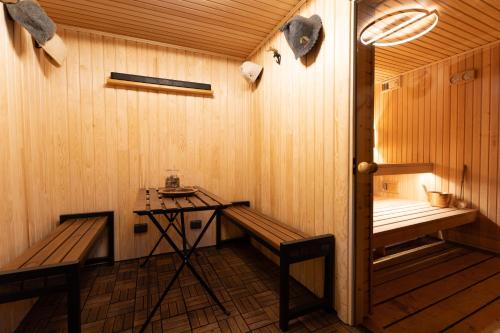 a sauna with a bench and a table in it at Piejūras māja skandināvu stilā! Seaside scandi house! in Lapmežciems