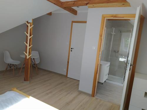 a bedroom with a shower and a glass door at u Tymka in Iława
