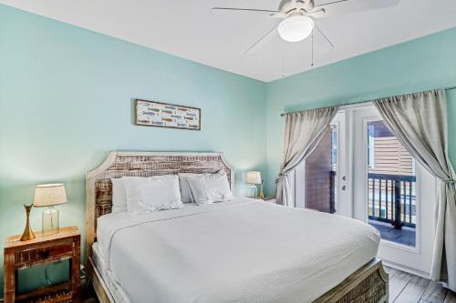 a bedroom with a bed and a window at Shark's Key in Port Aransas