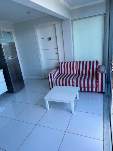 a living room with a couch and a coffee table at Residência Angra Deep Blue in Angra dos Reis