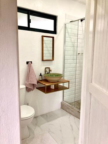 a bathroom with a sink and a glass shower at 180 at Mission House in Curryʼs Post