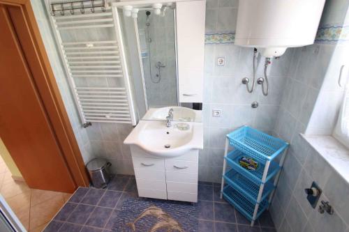 ein Bad mit einem Waschbecken und einem Spiegel in der Unterkunft Apartments in Jadranovo 39275 in Jadranovo