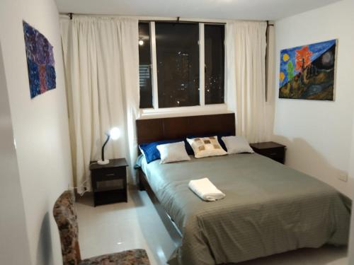 sypialnia z łóżkiem i oknem w obiekcie Habitaciones Centro Histórico w mieście Bogota