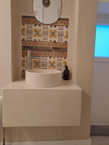 a bathroom with a white sink and a mirror at Palazzo AD 1892 - SUITES & SPA in Ostuni