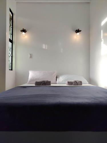 a bedroom with a bed with two pillows on it at Balai ni Meno in Butuan