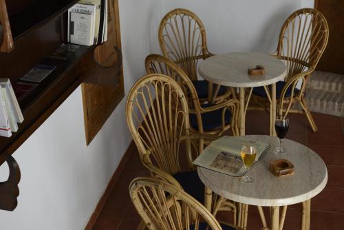 a couple of tables and chairs with wine glasses at Casa Rural Las Cadenas del Cananeo in Arcos de la Frontera
