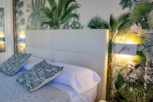 a bedroom with a white bed with two pillows at PARQUE SANTIAGO I Stunning brand new apt 2 bedroom Playa de las Américas in Playa de las Americas