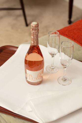 a bottle of wine and two wine glasses on a table at Cally Palace Hotel & Golf Course in Gatehouse of Fleet