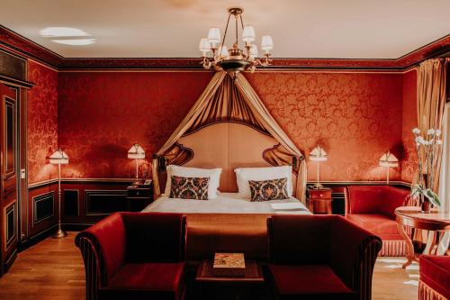 a hotel room with a bed and a couch at InterContinental Bordeaux Le Grand Hotel by IHG in Bordeaux
