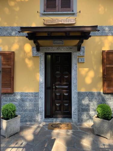 a front door of a house with two plants at Villa Angela in Dorio