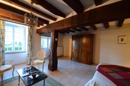 a bedroom with a bed and a table in a room at La Chancellerie in Huismes
