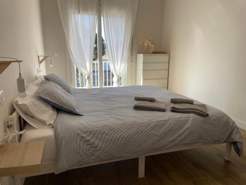 a bedroom with a bed with two towels on it at Costa Brava Villa in Platja d'Aro