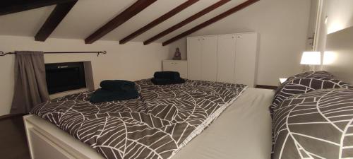 a bedroom with a bed with two black bags on it at Beautiful seaside 2 bedroom apartment Babina in Rabac