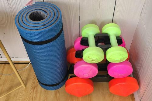 a pile of dumbbells next to a roll of blue ribbon at The Sailing Gypsy and Bunkie incl in pricing June 22-Sept 14 in Port Elgin