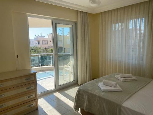 a bedroom with a bed and a large window at Three Bed villa, Private Pool in Didim