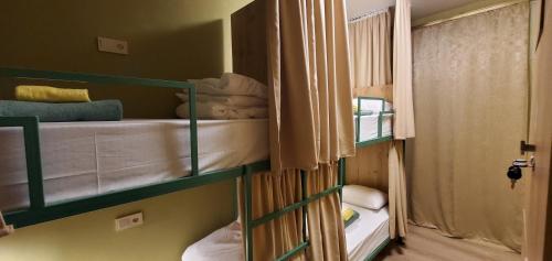 a room with two bunk beds in a room at La Casa EmilioAngi in Yerevan