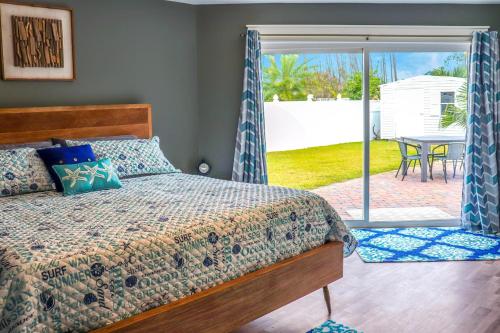 a bedroom with a bed and a patio with a table at The Sand Dollar in Mexico Beach