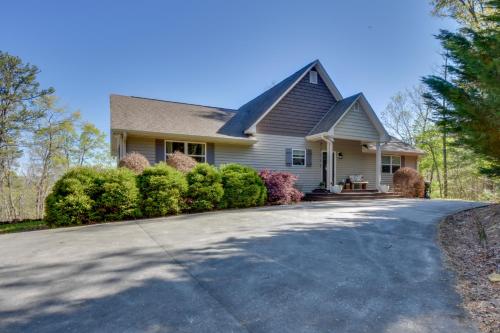 a house with a driveway in front of it at Lakemont Retreat Game Room, Hot Tub, and Mtn Views! in Lakemont