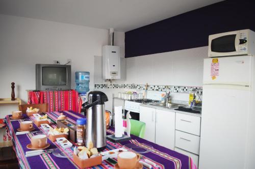 a kitchen with a table with food on it at D-Gira Hostel Jujuy in San Salvador de Jujuy