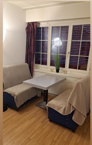 ein Wohnzimmer mit einem Tisch und einem Sofa in der Unterkunft Hotel Mam in St. Gallen