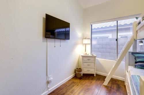 a bedroom with a bed and a tv on a wall at Upscale Cave Creek Home with Private Pool and Spa! in Cave Creek