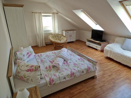 a living room with a couch and a tv at Pension St. Maria in Staré Hory