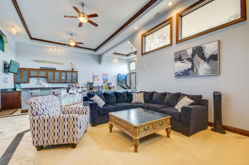 a living room with couches and a table at Boat Dock and Kayaks Luxury Lake of the Ozarks Home in Kaiser