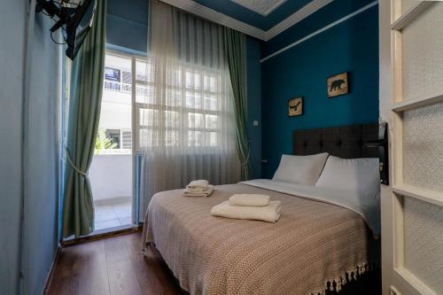 a bedroom with a bed with towels on it at Gold Coast Hostel in Antalya
