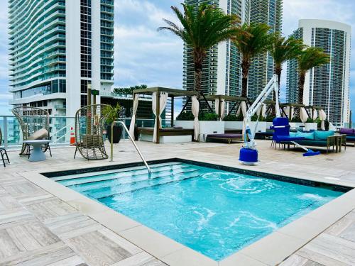 a swimming pool on the roof of a building with tall buildings at Hyde Beach House - Luxury 2-Bedroom - Gorgeous view - Resort amenities - Rooftop pool - Hot tub - Tennis court - Minutes to the ocean in Hollywood