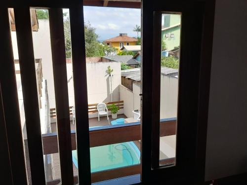 a view of a pool from a window at Por do Sol in Florianópolis