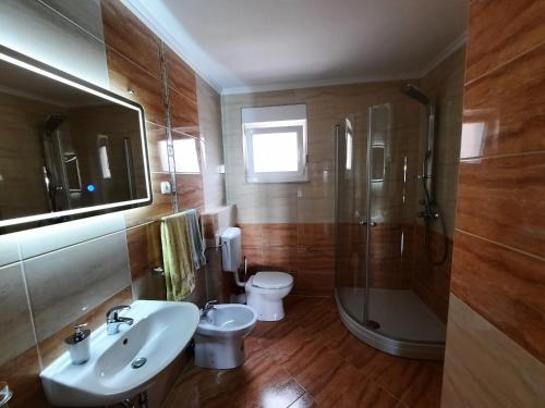 a bathroom with a sink and a shower and a toilet at Villa Maja in Trogir