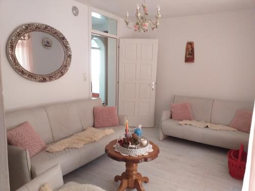 ein Wohnzimmer mit einem Sofa und einem Tisch mit einer Kerze in der Unterkunft Vila sumska idila in Banja Koviljača