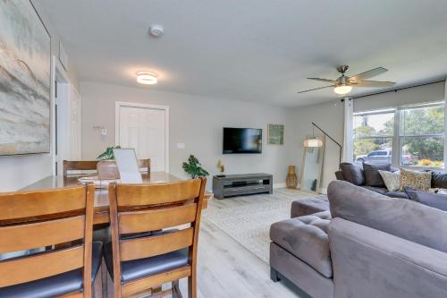 a living room with a table and a couch at Coastal Sarasota Condo Minutes to Beach! in Sarasota