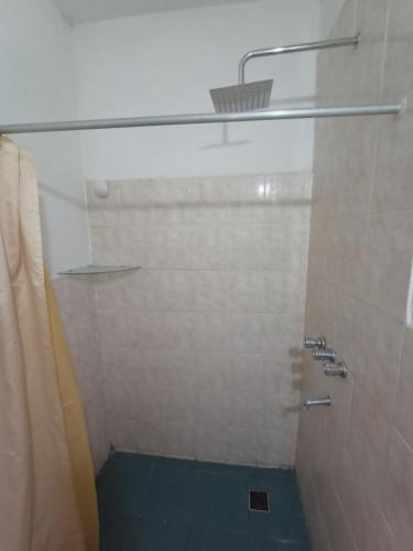 a bathroom with a shower with a blue floor at TU LUGAR in Villa Cura Brochero
